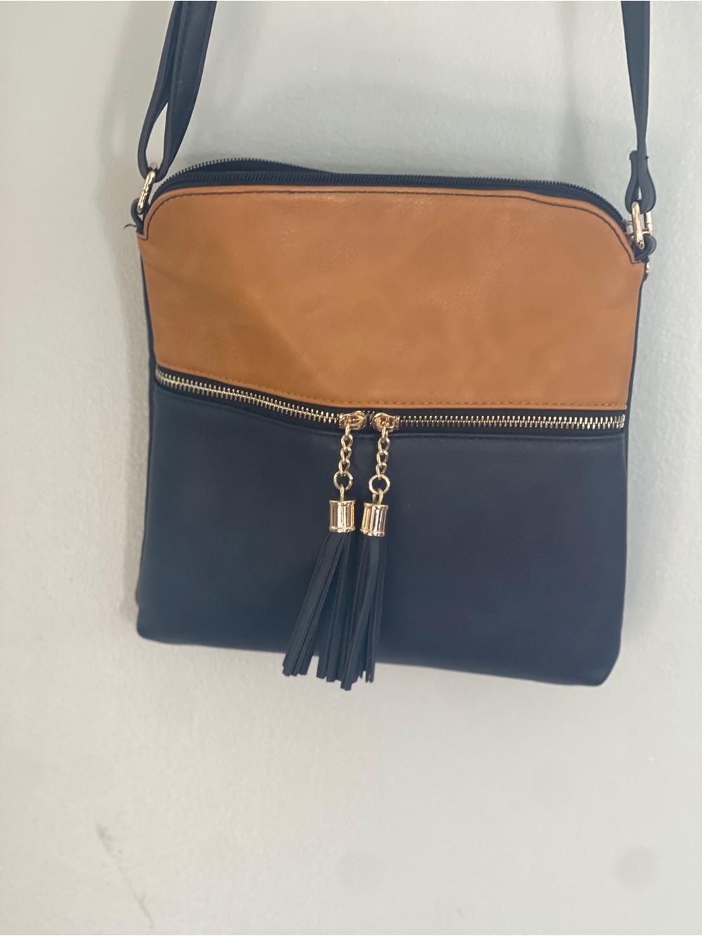 Two-Tone Black and Tan Crossbody Bag with Tassel Zip